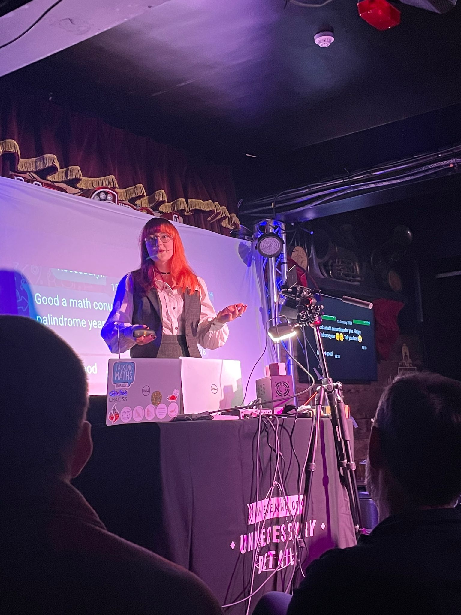 Kat speaking at an evening of unecessary detail